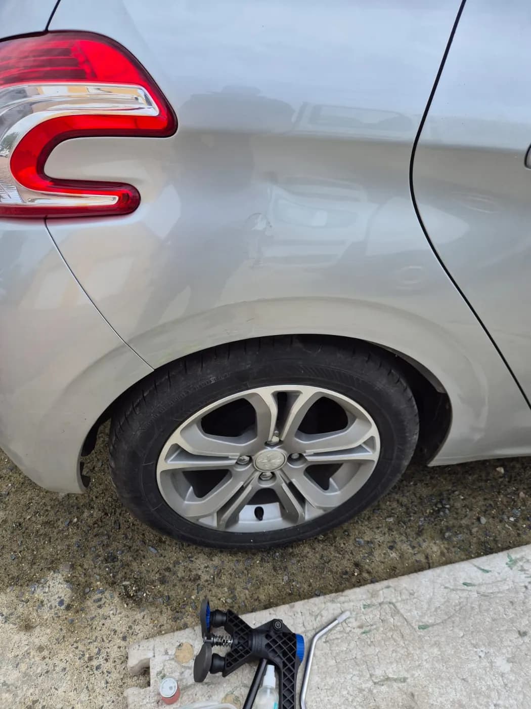 Après — aile arrière enfoncée d'une Citroën grise, remise en forme sans peinture